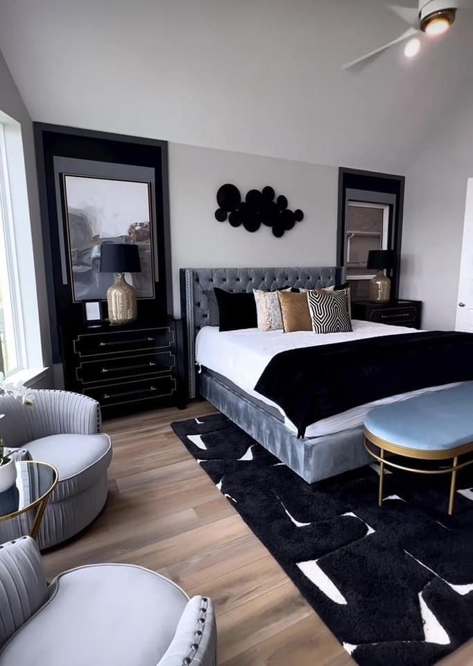 a bedroom with black and white decor in it