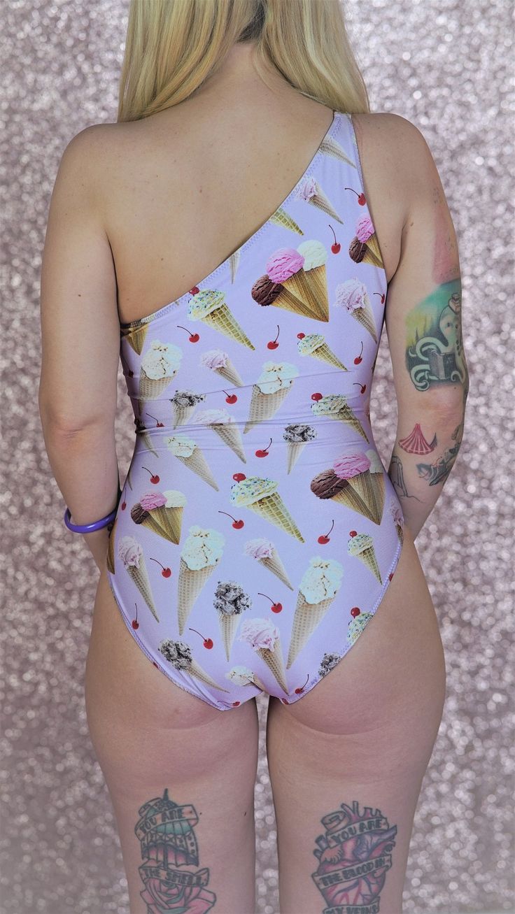 Look cool even on the hottest summer days on the beach with The Frostine Asymmetrical Swimsuit! This unique, ice cream printed swimsuit is sure to sweeten up any ensemble with its cheeky coverage. So don't be a cone-head and get your scoop of sass on today! 1st Model is wearing a size Medium 2nd Model is wearing size 1X Asymmetrical Swimsuit, Unique Ice Cream, Cone Head, Vinyl Raincoat, Ice Cream Print, Photoshoot Themes, Print Swimsuit, Blue Moon, Look Cool