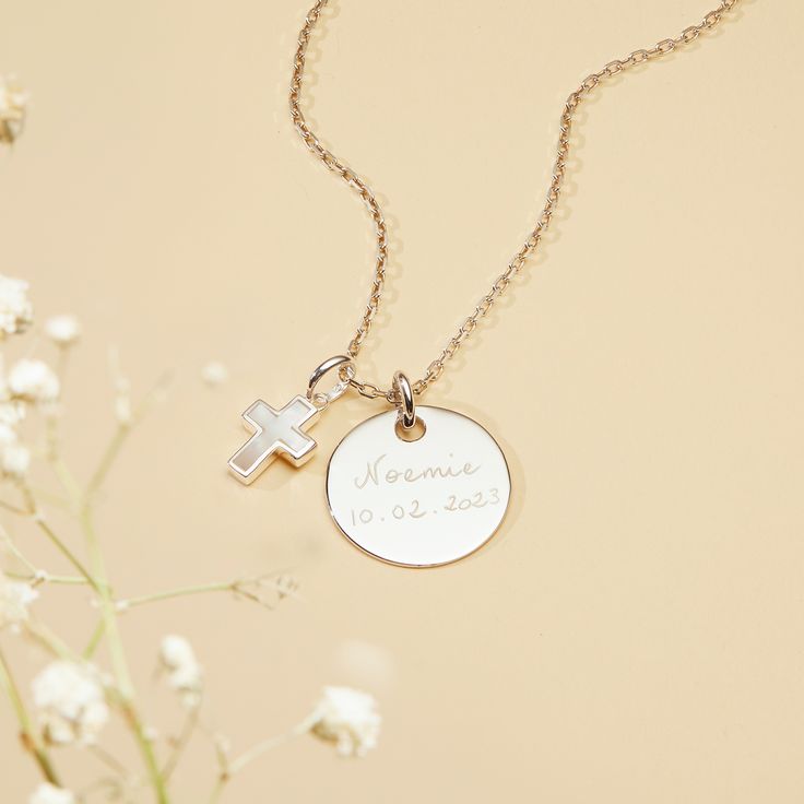 The perfect personalized necklace to celebrate a christening or communion. Cherish special memories with our Personalized Mother of Pearl Cross Necklace. Hand-engrave precious dates or names onto the front and reverse of your preferred disc and pair with an elegant mother-of-pearl cross charm. 18K Champagne Gold Plated or 925 Sterling SilverSmall Flat Disc: 0.6 x 0.6Medium Flat Disc:  0.7 x 0.7Mother of Pearl Cross: 0.4 x 0.3Charms are removable from this chain and can be worn on all Merci Maman Personalized Engraved Cross Necklace, Wedding Cross Pendant Necklace With Engraving, Engraved Cross Pendant Necklace For Wedding, Wedding Engraved Cross Pendant Necklace, Personalized White Gold Cross Necklace, Personalized White Gold Cross Pendant Necklace, Engraved Cross Necklace For First Communion, Silver Engraved Necklace For Baptism, Personalized Yellow Gold Necklaces For First Communion