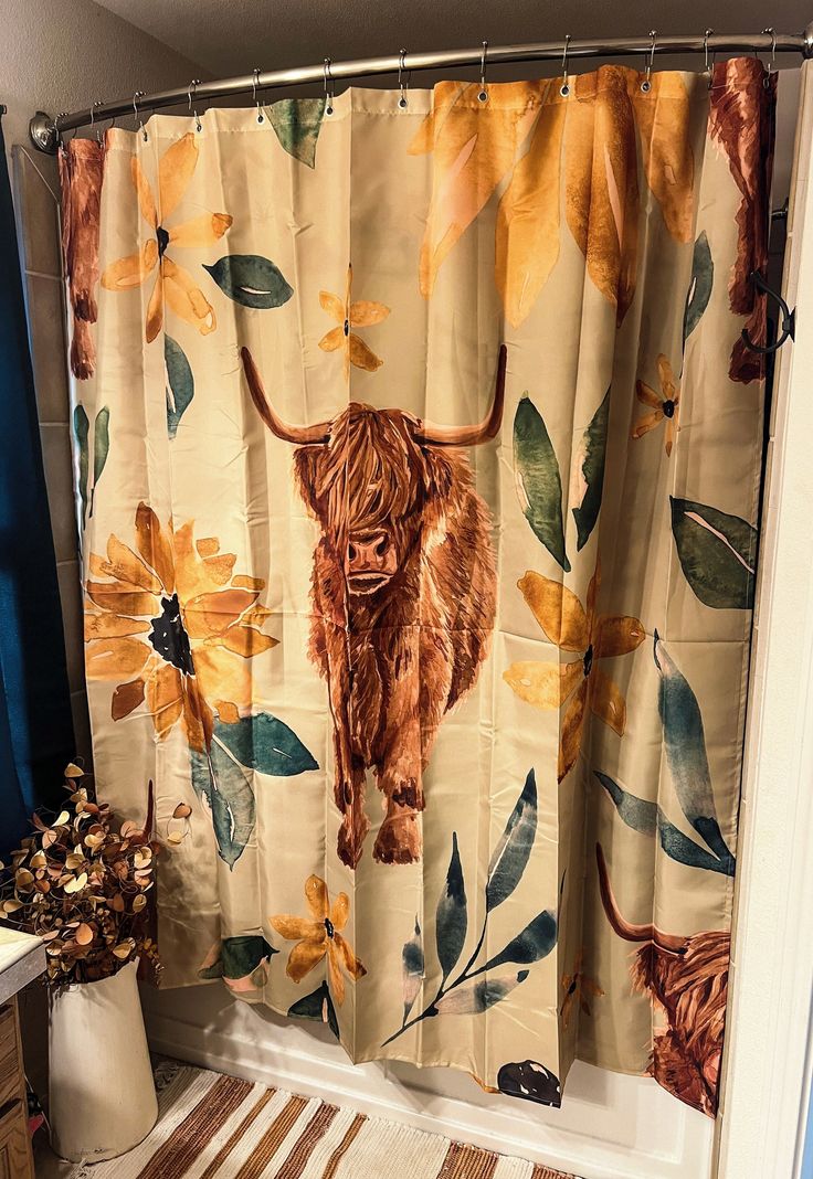 the shower curtain is decorated with an image of a bull and sunflowers on it