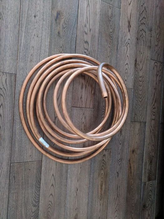 a bunch of brown hoses laying on top of a wooden floor