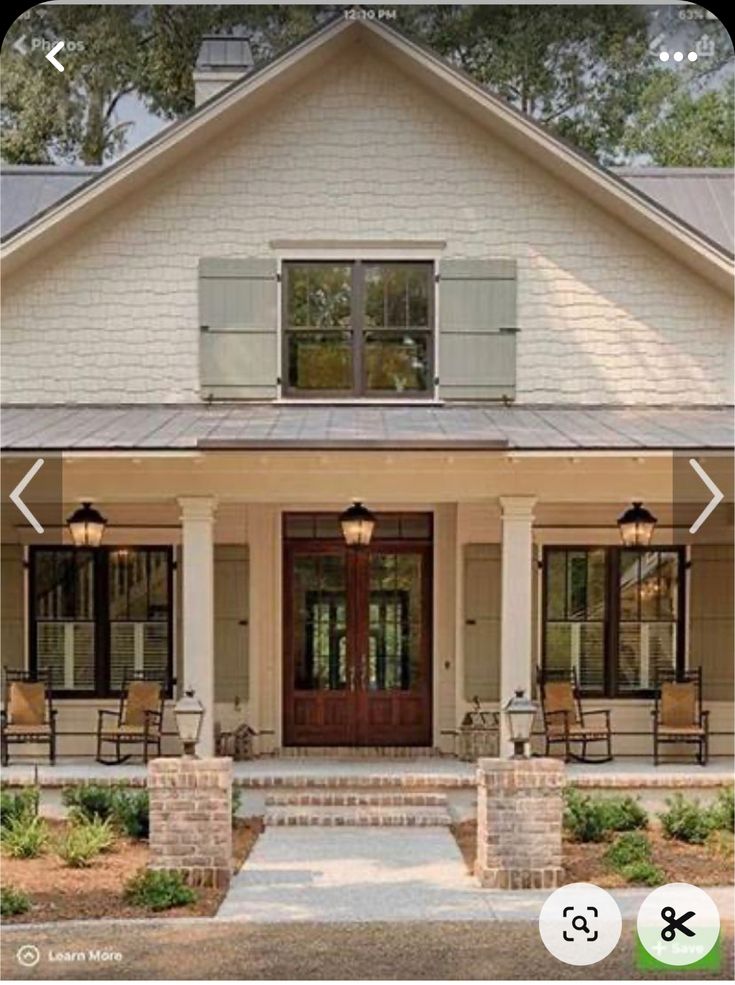 a house with two porches and chairs on the front door, windows in the back