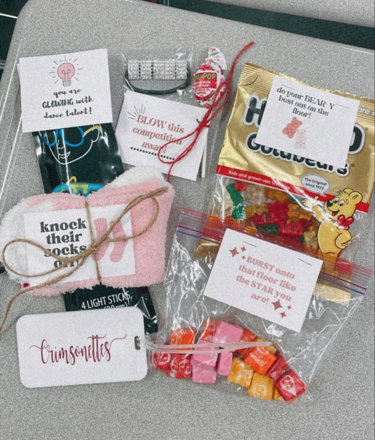 some candy bags are sitting on the counter next to other packaged treats and candies