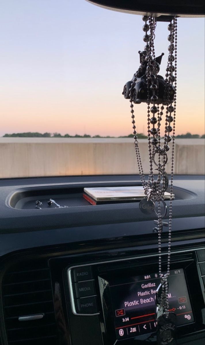 a car dashboard with a chain hanging from the dash