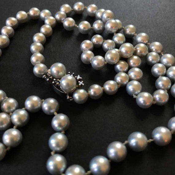 This is a stunning genuine pearl necklace with handknotted 6 MM silver pearls, closed with  14k Solid white gold clasp that is set with pearls and sapphires. The clasp is marked "H" and 14k. This piece is from the 1960's or 1970's at my best estimate. The pearls are genuine cultured pearls as best as I can tell, and pretty high quality. The clasp is unusual and also very high quality. The necklace is 26 inches long total length with 6 mm pearls, that's over 100 pearls. The clasp is 5/8 inches lo Classic Tahitian Pearl Necklace With Round Beads, Formal Single Strand Tahitian Pearl Necklace, Classic Tahitian Pearl Necklace With High Luster, Classic Round Tahitian Pearl Necklace, Classic Tahitian Pearl Necklace In White Gold, Elegant Tahitian Pearl Jewelry With Round Beads, Classic White Gold Tahitian Pearl Necklace, Formal Tahitian Pearl Necklace, Elegant Single Strand Tahitian Pearl Necklace