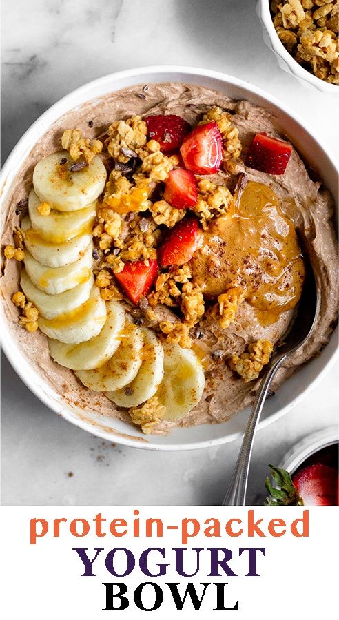 a bowl of oatmeal topped with sliced bananas and strawberries