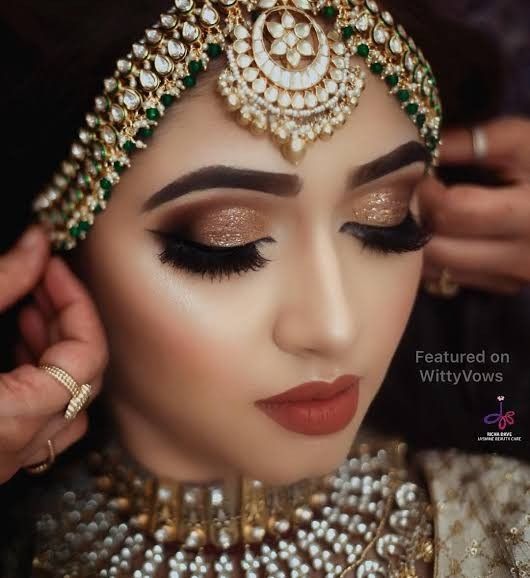 a woman with makeup and jewelry on her face is getting ready to go into the wedding ceremony