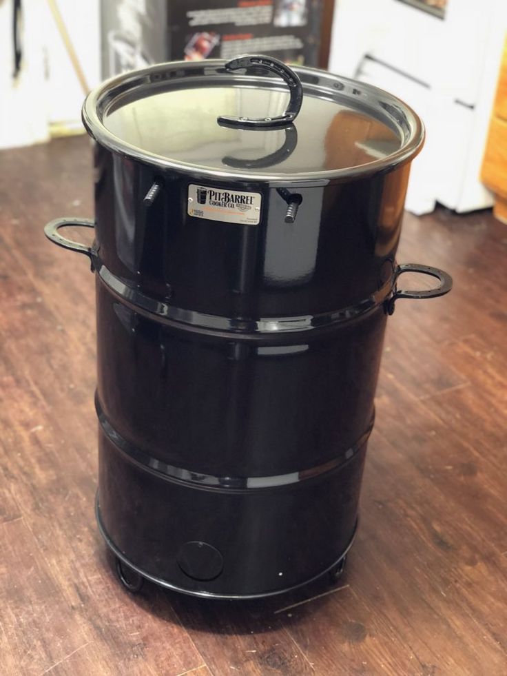 a large black pot sitting on top of a wooden table