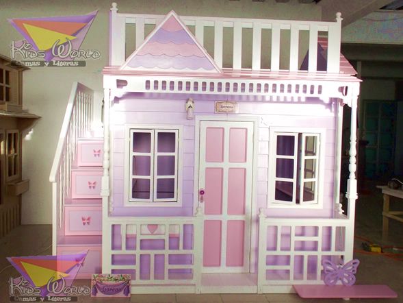 the doll house is made out of wood and has pink trimmings on it