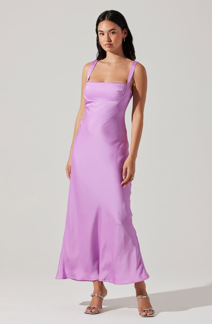 a woman wearing a purple dress with straps and an asymmetrical neckline