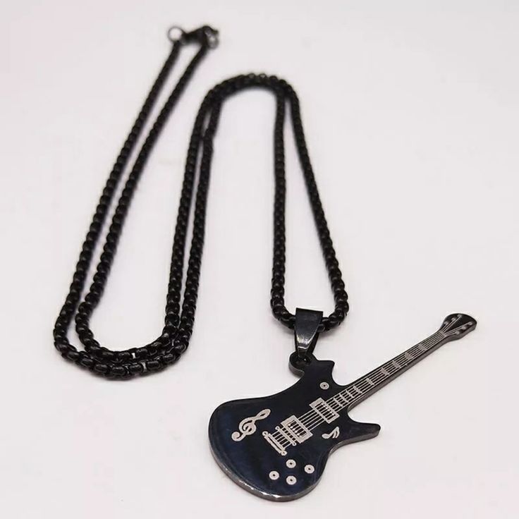 Stainless Steel Pendant. Stainless Steel Chain. Lobster Clasp Closure. Casual Black Chain Necklace, Edgy Black Stainless Steel Necklace, Black Metal Necklaces For Concerts, Black Chain Jewelry For Concerts, Black Chain Necklace For Concert, Black Metal Rocker Jewelry, Black Metal Rocker Style Jewelry, Black Rocker Style Metal Jewelry, Black Metal Rock Style Jewelry