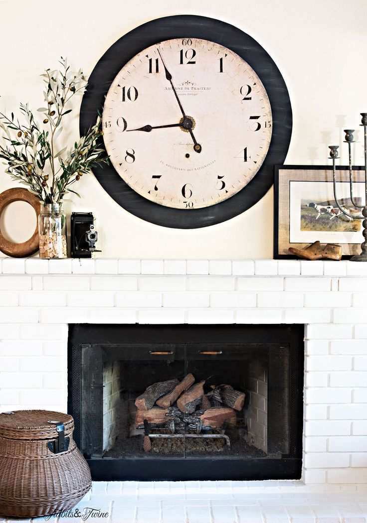 a fireplace with a clock on the wall above it