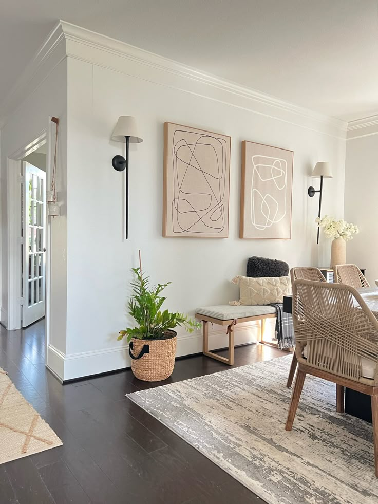 a living room filled with furniture next to a dining room table and two planters