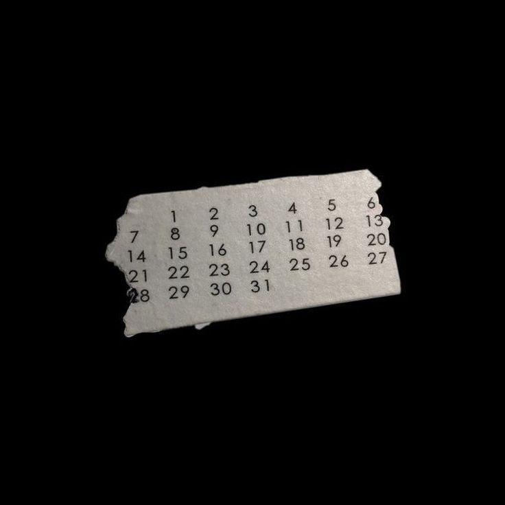 a white ticket with numbers on it in the dark