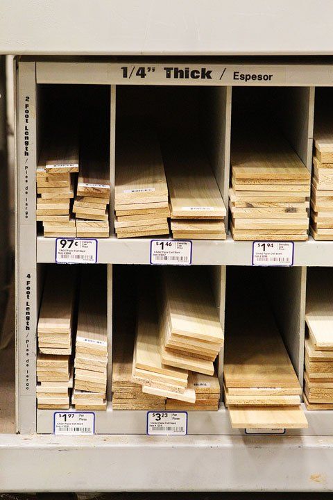 stacks of wood stacked on top of each other in a storage unit at a store