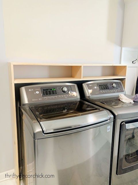 a washer and dryer sitting next to each other in a room with white walls