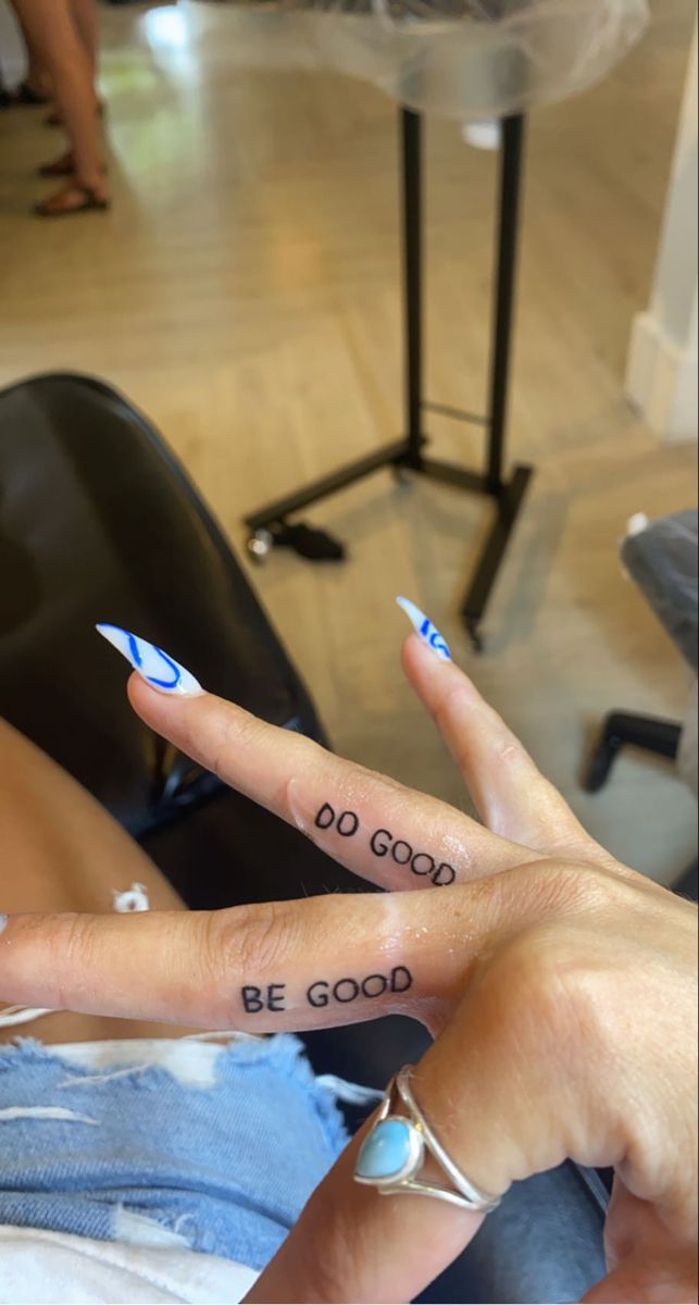 two people with matching tattoos on their fingers, one is saying be good to the other