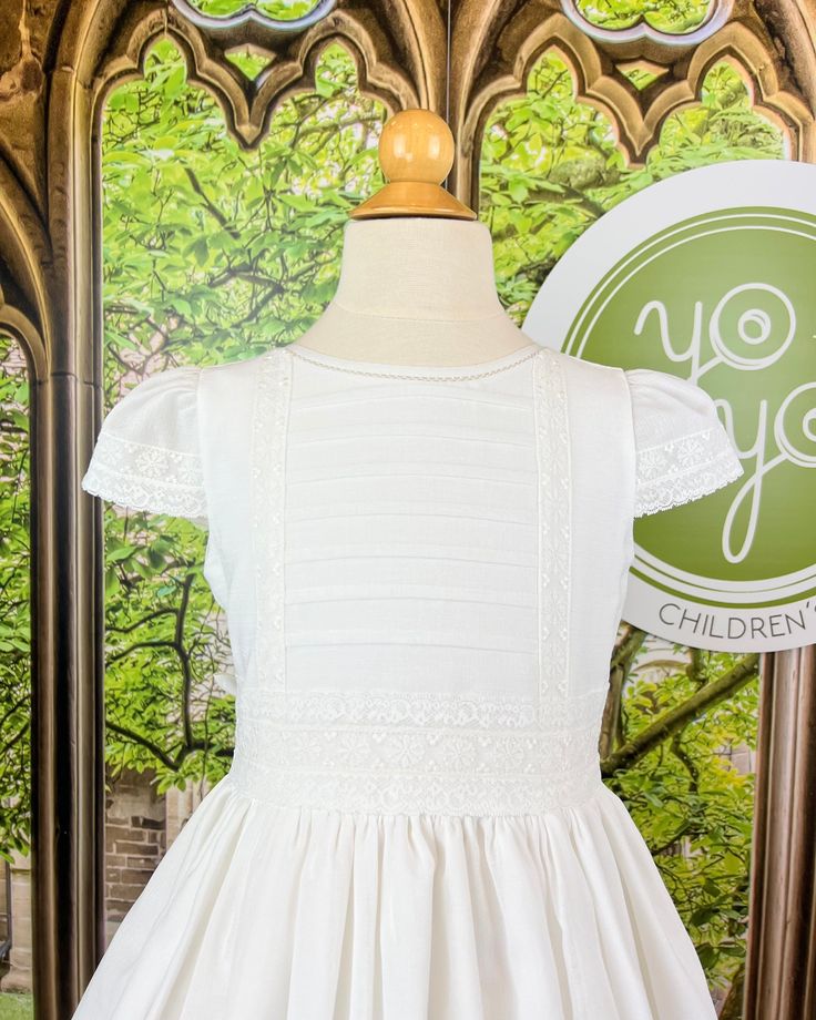 Beautiful first communion dress, made with natural white linen. The dress has minimalistic pleats and delicate floral laces. It has buttons on the back for closure, and strings to form a bow. Made in Spain Dry Clean Final sale, no exchanges nor returns will be processed after purchase Fitted First Communion Dress With Ruffles For Ceremony, Fitted Ruffled First Communion Dress, Cream Fitted First Communion Dress For Spring, Fitted Cream First Communion Dress For Spring, Fitted First Communion Dress With Ruffles, Classic Dresses With Fitted Bodice For First Communion, Classic Fitted Dress For Confirmation, Fitted Dress With Pleated Bodice For First Communion, White Classic Dress For First Communion