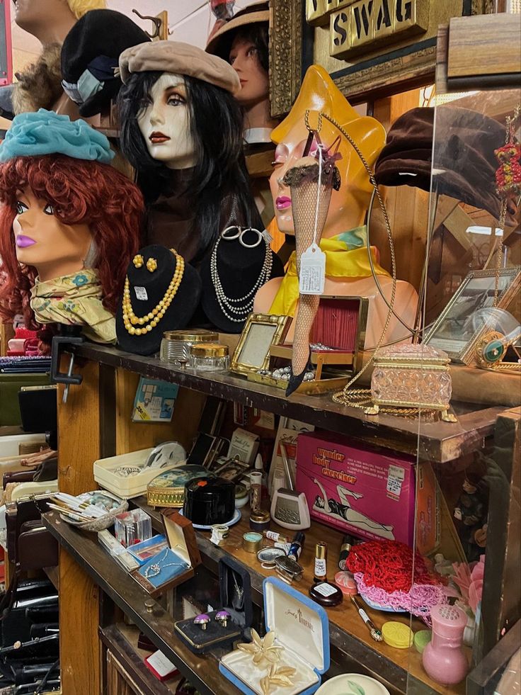 many mannequins and hats are on display in a room with wooden shelves