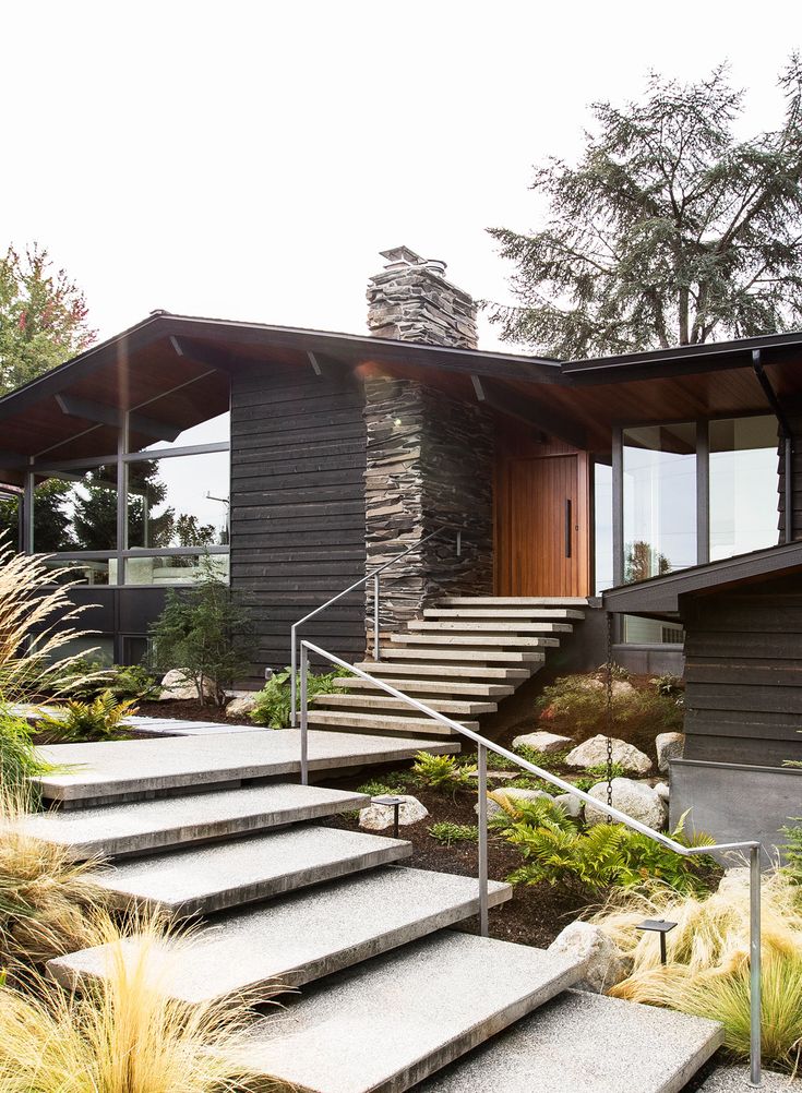 an exterior view of a modern house with stone steps