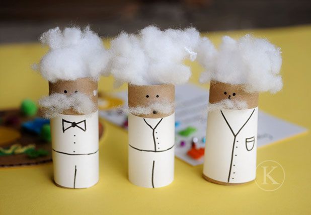 three toilet paper roll figures with hair on them