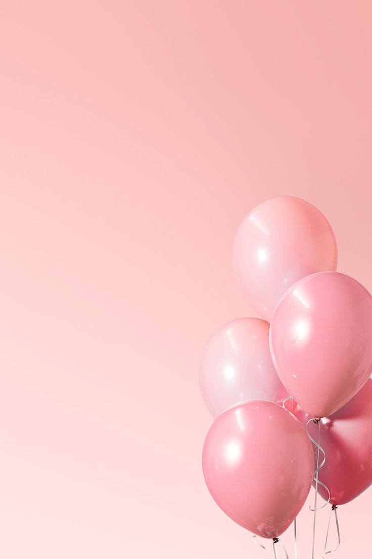 a bunch of pink balloons floating in the air