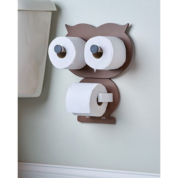 an owl shaped toilet paper dispenser mounted to the wall