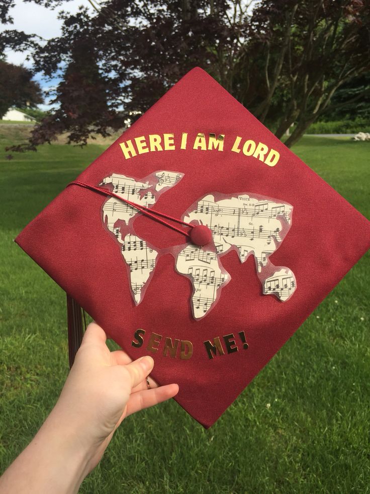 someone is holding up a red graduation cap with the words here i am lord and world map on it