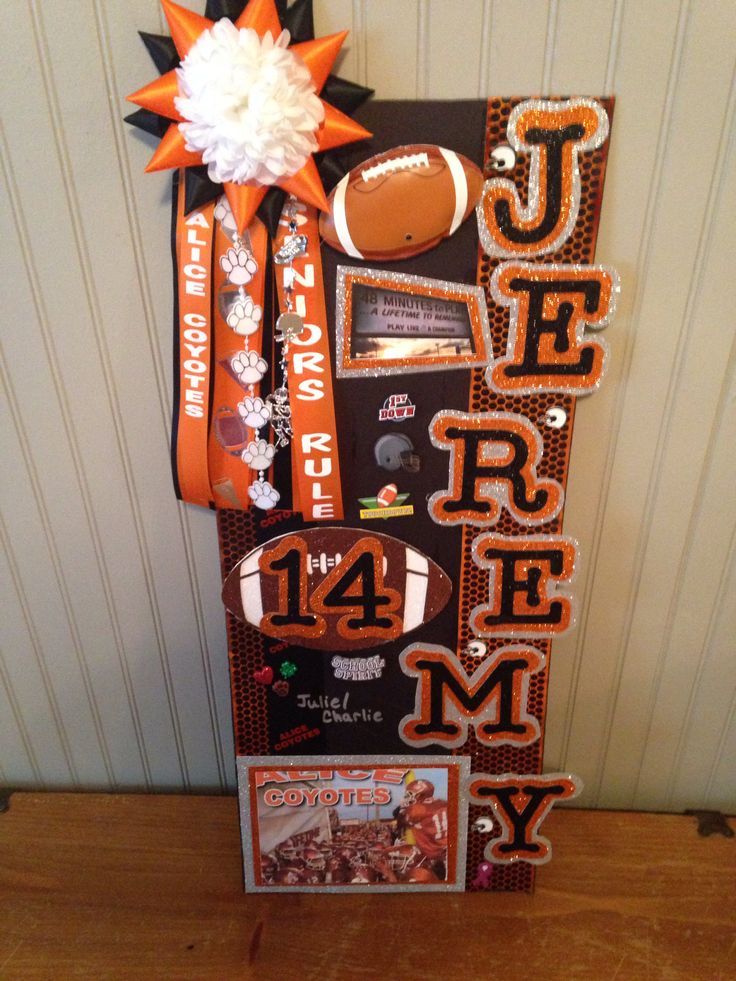 a football themed door hanger with an orange ribbon