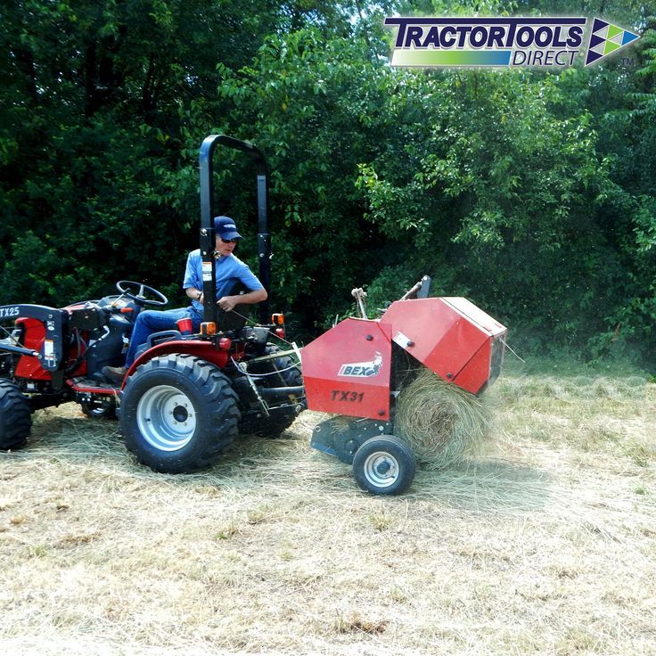 a man riding on the back of a red tractor