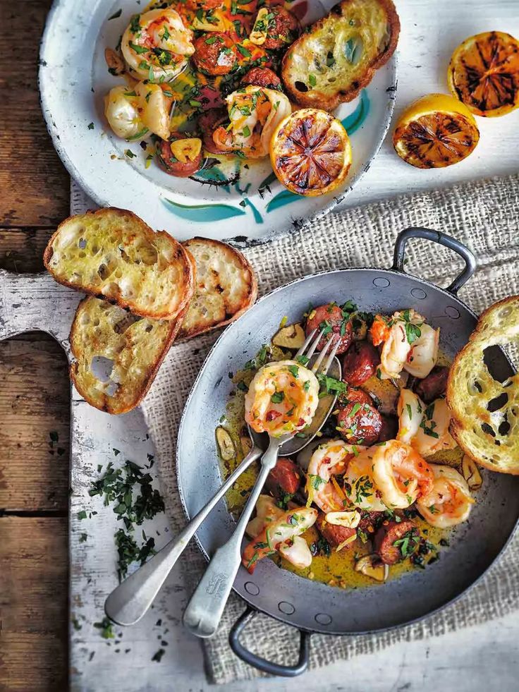 two plates of food on a table with bread