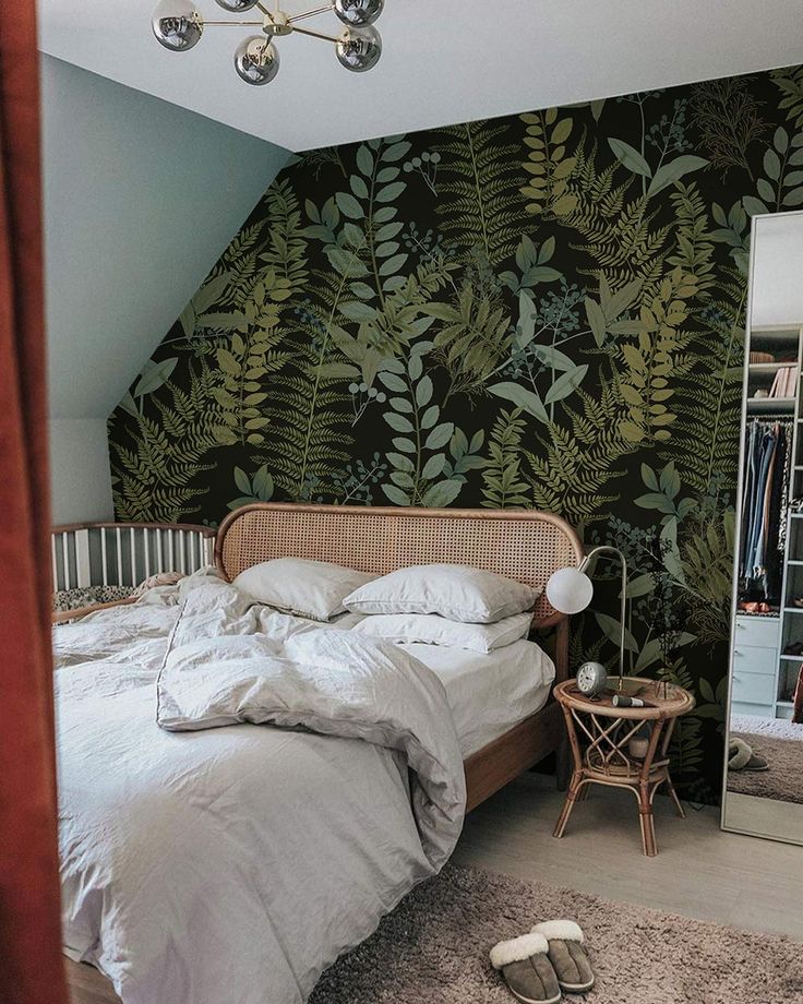 a bedroom with a bed, mirror and lamp on the floor next to a closet