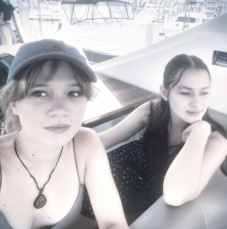 two women sitting in the back of a boat