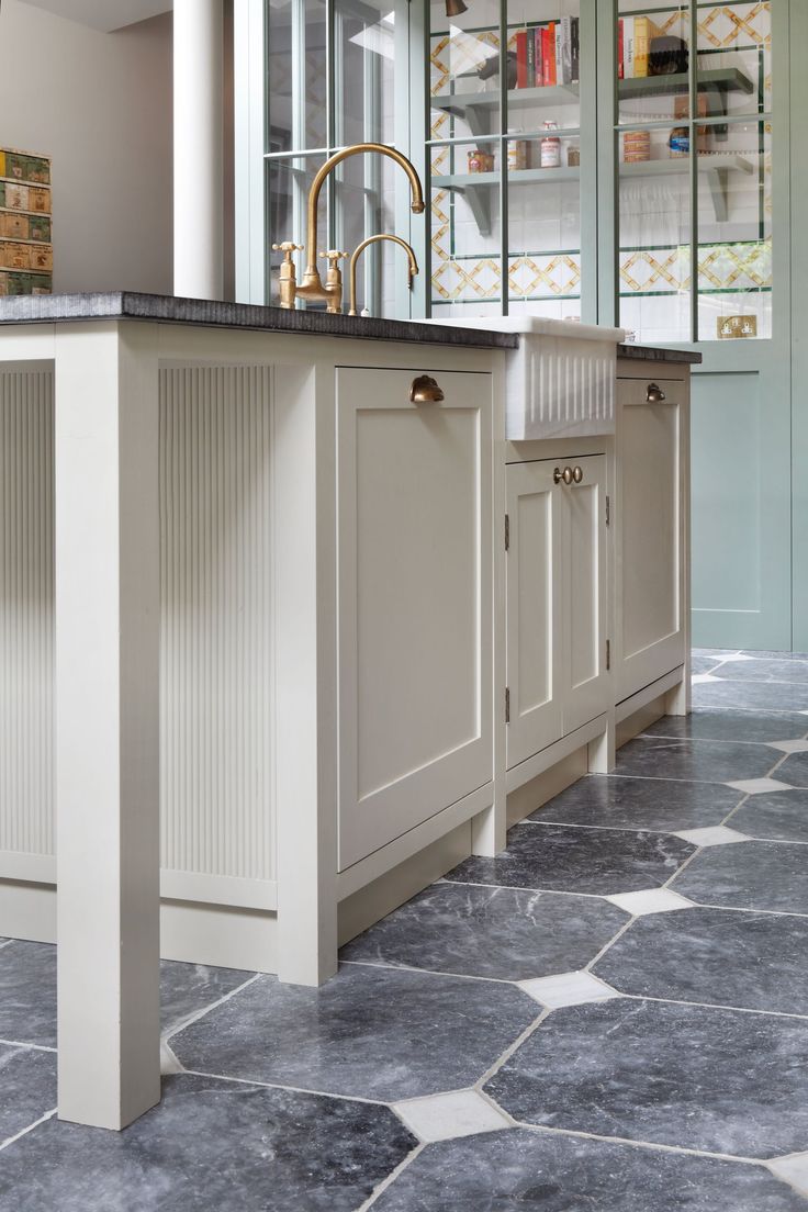 a kitchen with marble flooring and white cabinets