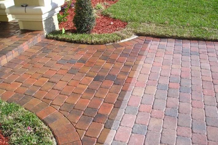 a red brick walkway in front of a house