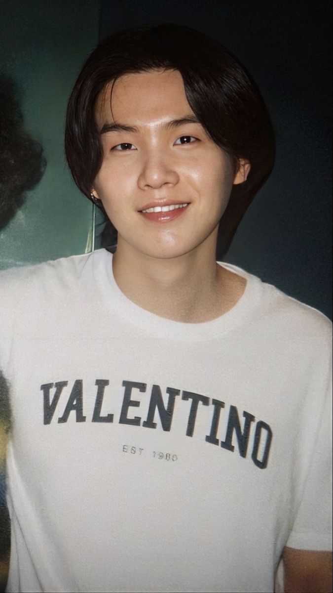 a young man wearing a white shirt with the word valentine on it