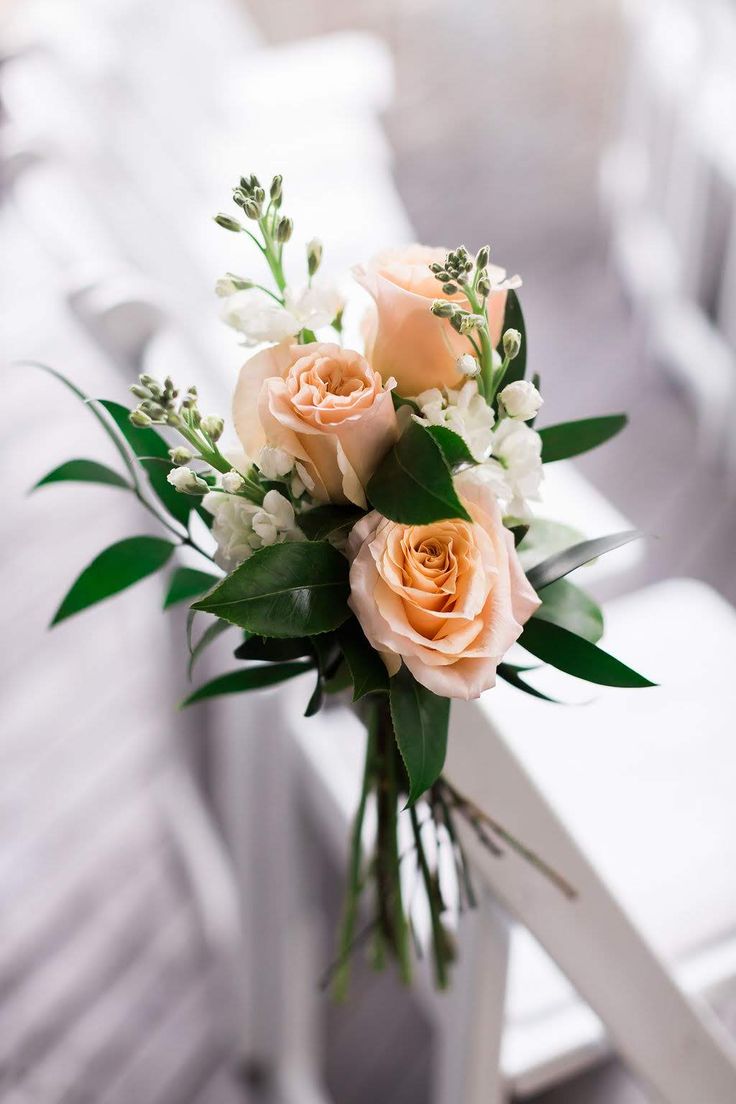 a bouquet of flowers sitting on top of a white chair