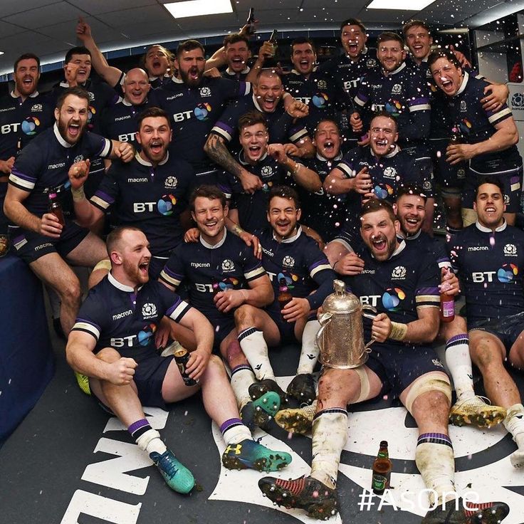 the rugby team is celebrating with their trophy