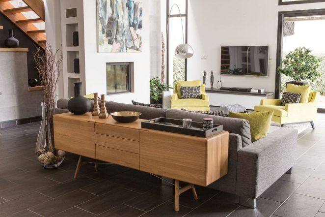 a living room filled with furniture and a fire place in the middle of a room