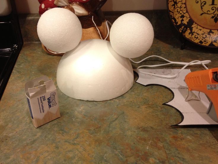 a close up of a snowman on a kitchen counter with an orange blower