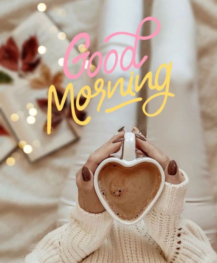 a woman holding a coffee mug with the words good morning in front of her face