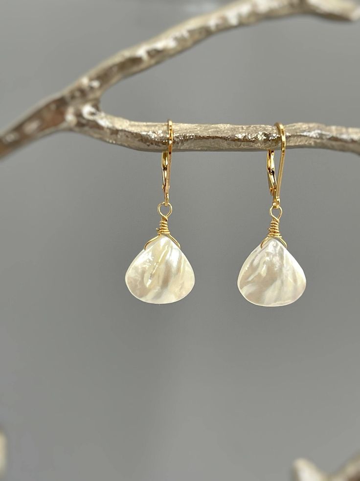 Handmade Mother of Pearl Dangle Earrings.   Dainty Iridescent mother of pearl shell tear drops are set in your choice of 14k gold fill, sterling silver or solid 14k gold and hang from your choice of leverbacks or French hook ear wires. Mother of Pearl drops are approx 14x14mm (about 5/8" long).  Simple, elegant earrings perfect summer or beach wedding earrings. The matching necklace is available for purchase separately in our store. PLEASE note measurements and size reference pictures. Our jewel Shell-shaped Pearl Drop Earrings For Gifts, Shell-shaped Pearl Charm Earrings As Gift, High Luster Teardrop Pearl Earrings, Mother Of Pearl Earrings With High Luster For Gifts, White Teardrop Mother Of Pearl Jewelry, Pearl Drop Shell-shaped Earrings For Gift, Briolette High Luster Pearl Earrings As Gift, Briolette High Luster Pearl Earrings For Gift, High Luster Briolette Pearl Earrings As Gift