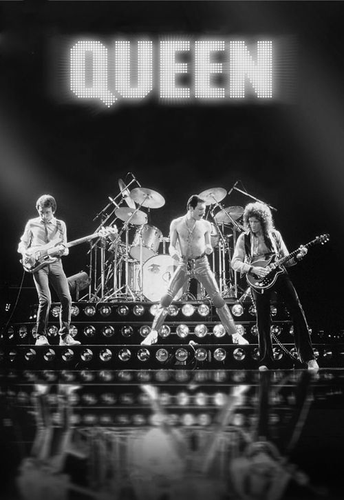 the queen band performing on stage with their guitars