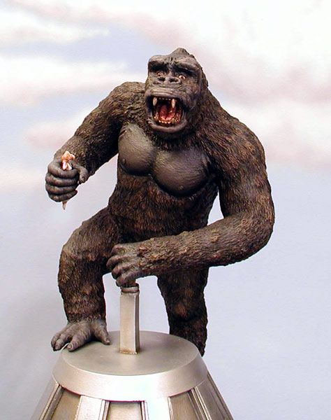 there is a statue of a gorilla on top of a lamp post with its mouth open