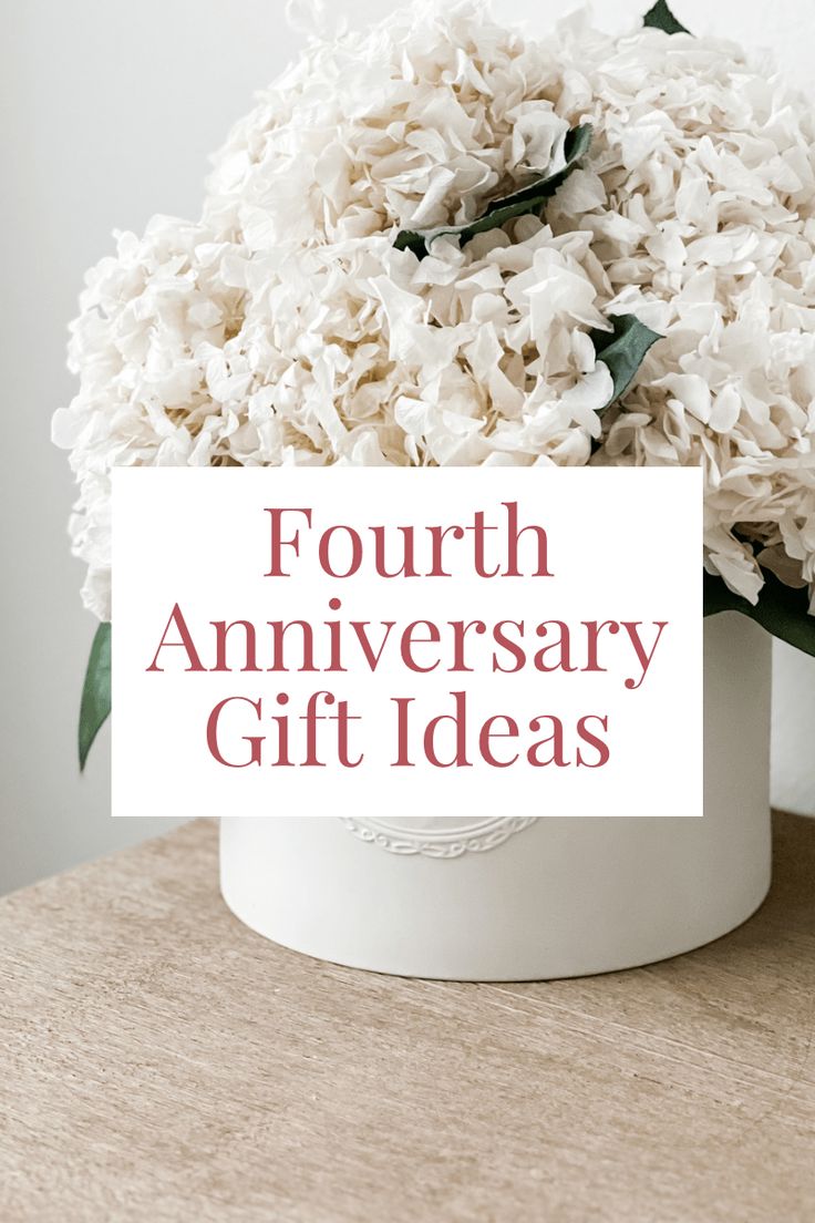 a white vase filled with flowers and the words fourth anniversary gift ideas written on it