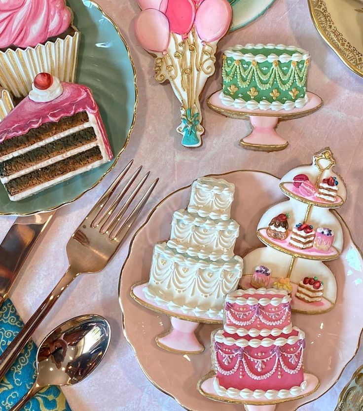 a table topped with plates filled with cakes and desserts