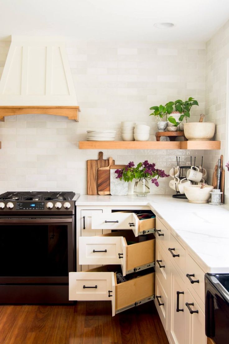 an open drawer in the middle of a kitchen