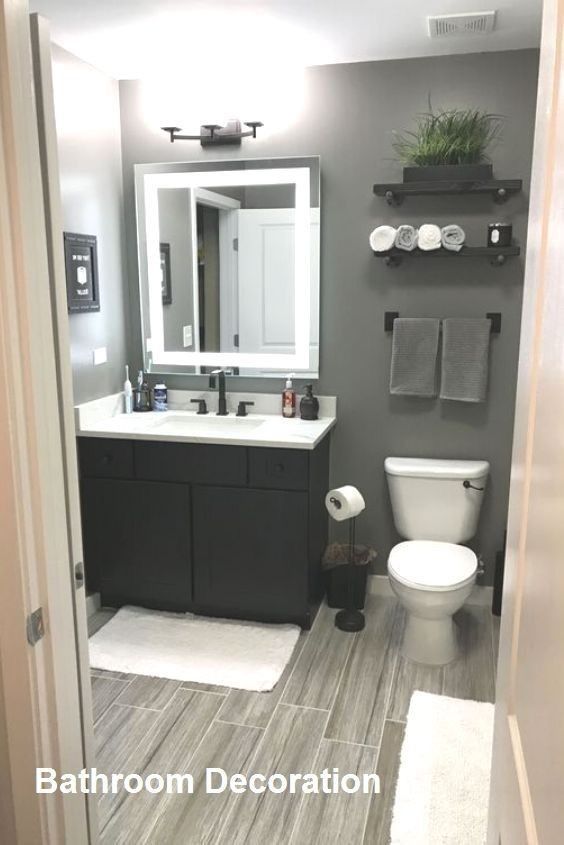 a bathroom with a toilet, sink and mirror