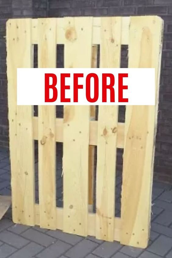 a wooden crate sitting on top of a sidewalk next to a brick wall with the words before written in red