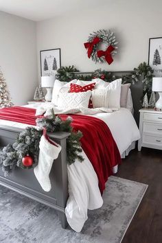 a bedroom decorated for christmas with red and white decor